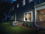 A Briggs and Stratton 20kW Model 40625 150 Amp Generator System Outside a Home With the Lights on During a Power Outage