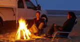 Beach camping bonfire with a truck camper and Onan 2500i LP Generator