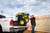 Contractor on a Job Site Guides a Champion 12000 Watt Generator Carried by the Lift Hook Onto a Pickup Truck