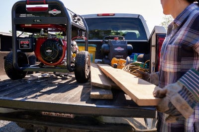 Elite Series Portable Generators with up to 10,000 Starting Watts Handle Big Jobs and Work Hard All Day Long 8000-Watt Briggs and Stratton Elite Series Portable Generator on the bed of a Farm Truck with Lumber and Tools.