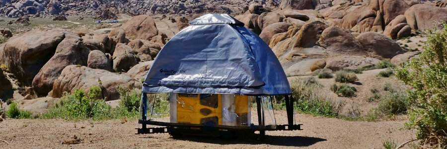 GenTent 10K Installed on a Portable Generator with Clear Plastic Skirt in the Mountains