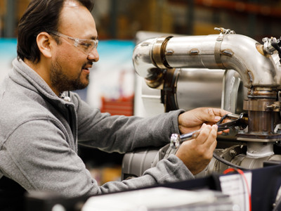 A technician works on a Kubota Generator Engine