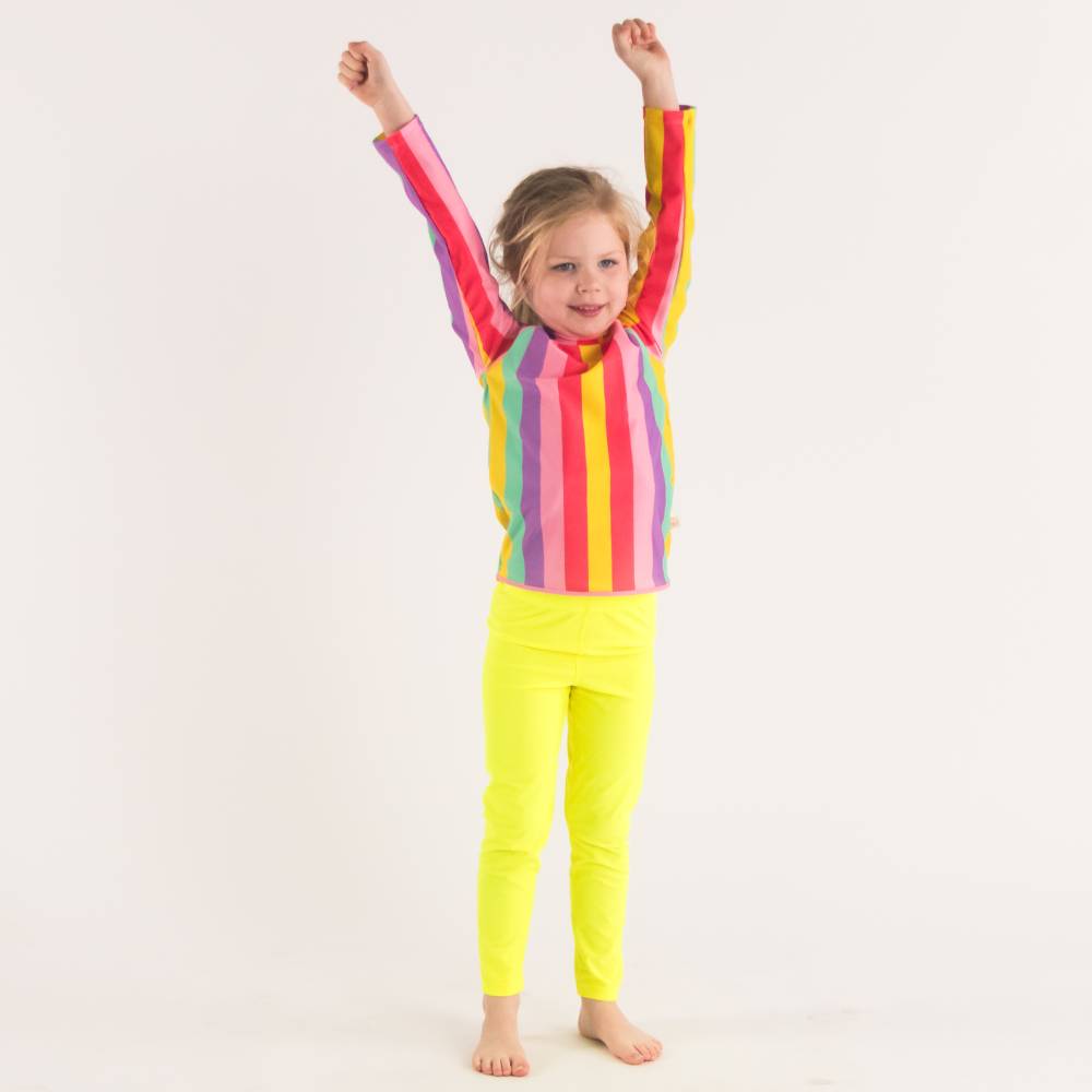 Girl standing in Neon Yellow Swim leggings with Stripe Swim Rash Vest - front shot, hands up