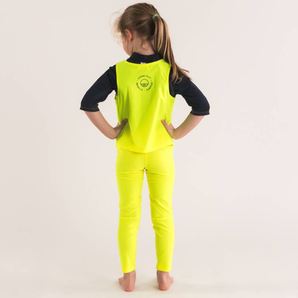 Girl standing in Neon Yellow Swim leggings with Neon Yellow Be Seen Over Vest - back shot