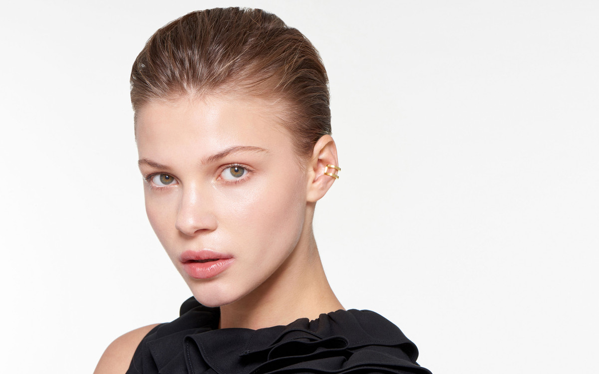22 karat gold ear cuffs in polished finish adorning elegant female model