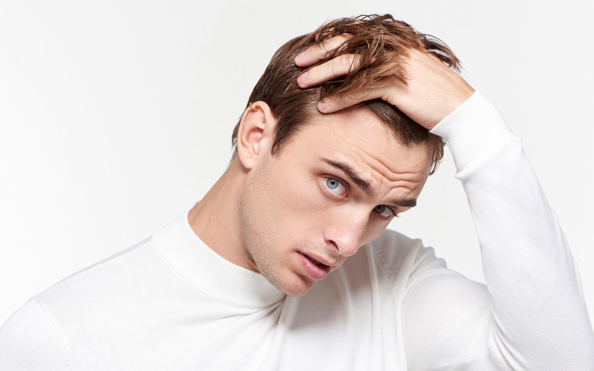 Man model wearing 22 karat gold earring