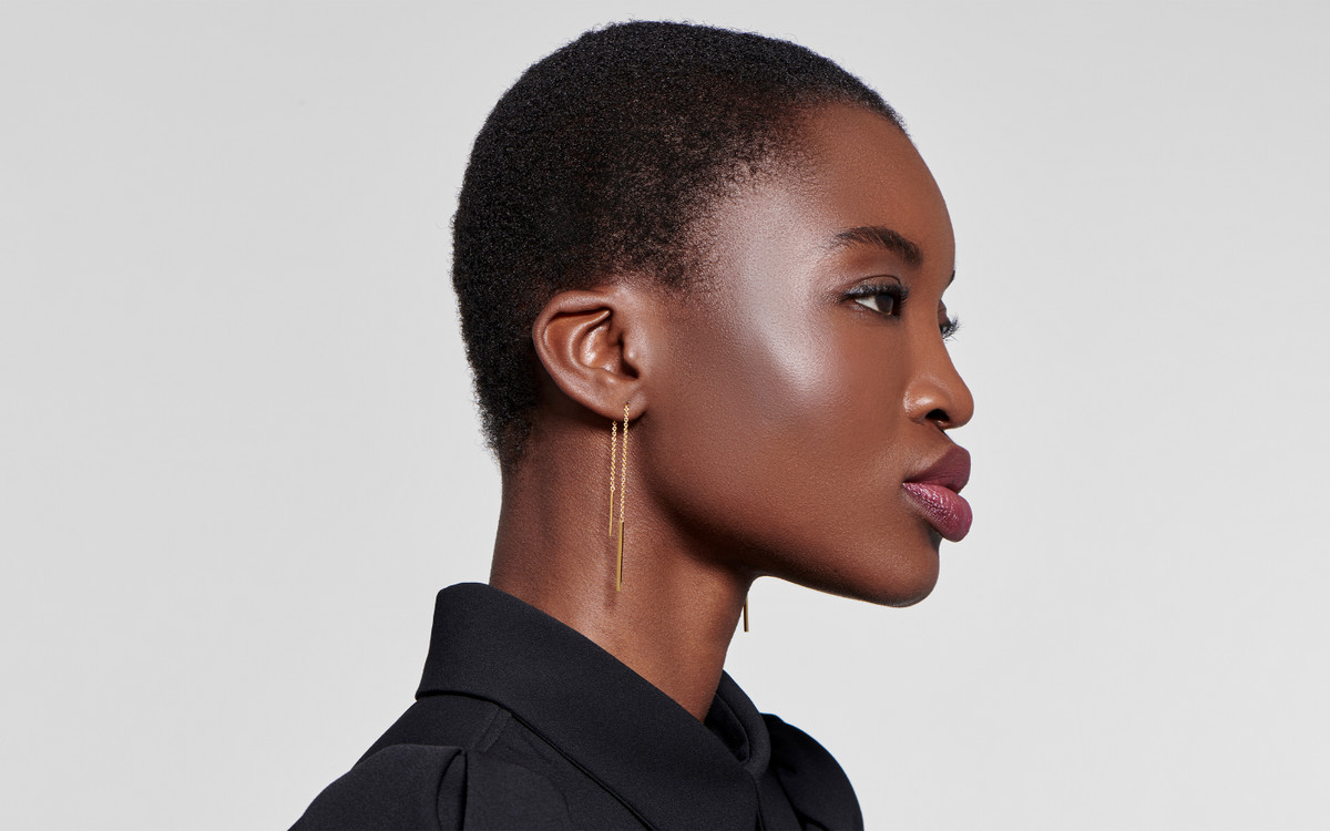 Woman model wearing 22 karat gold earring