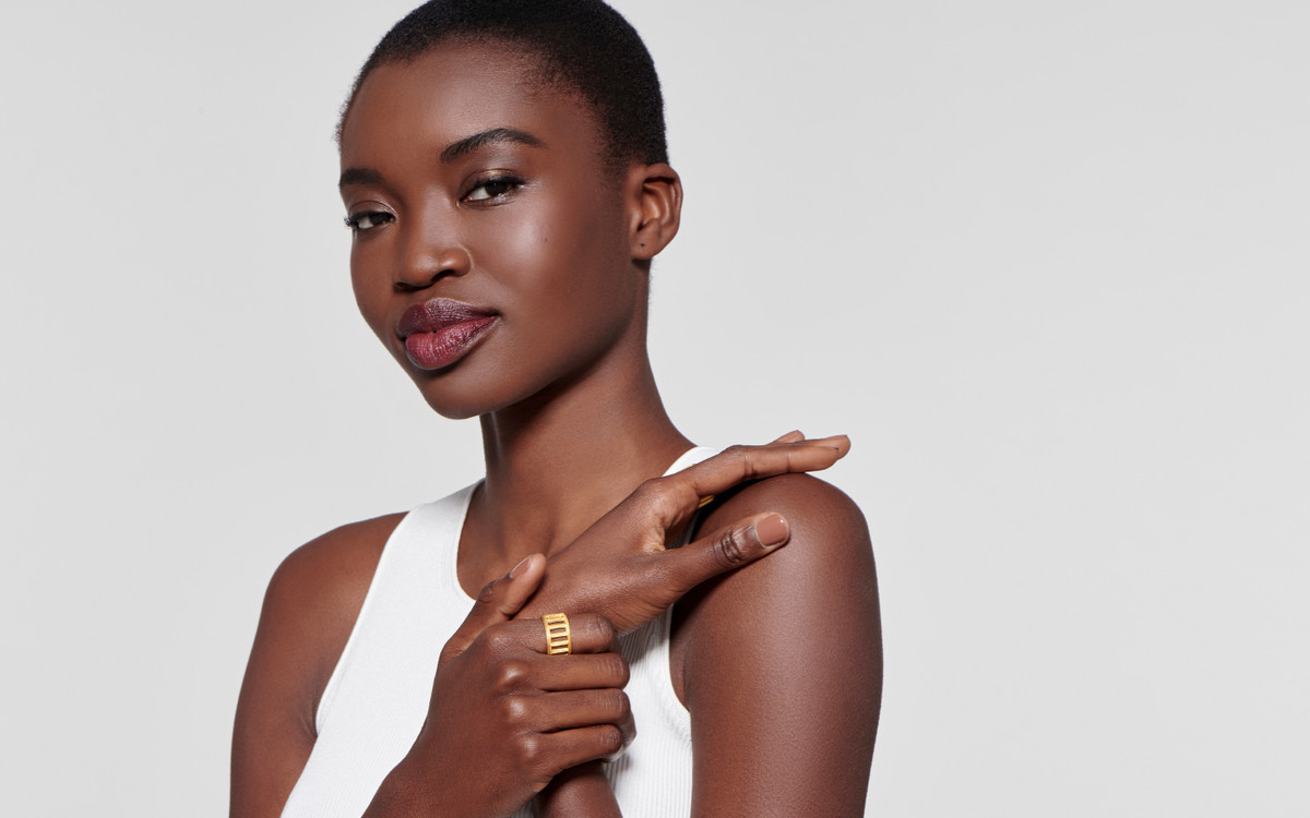 stunning female model exhibiting an unbelievable satin finished 22 karat gold ring modeled after legendary western columns