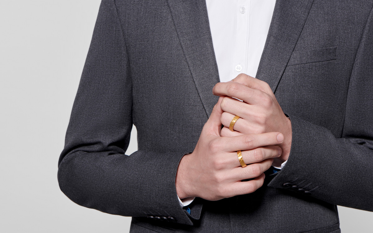 Male model wearing 22 karat gold wedding band