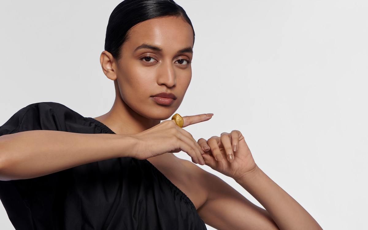 Woman model wearing 24 karat gold ring