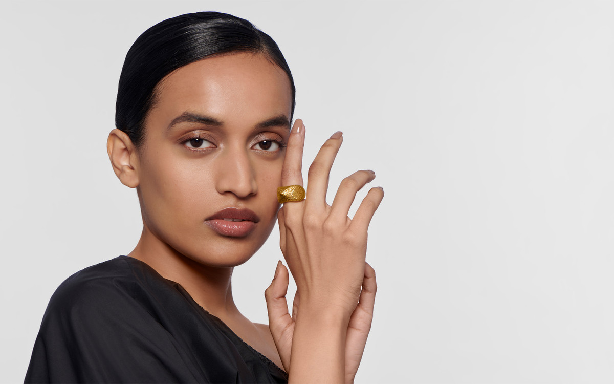 Woman model wearing 24 karat gold ring