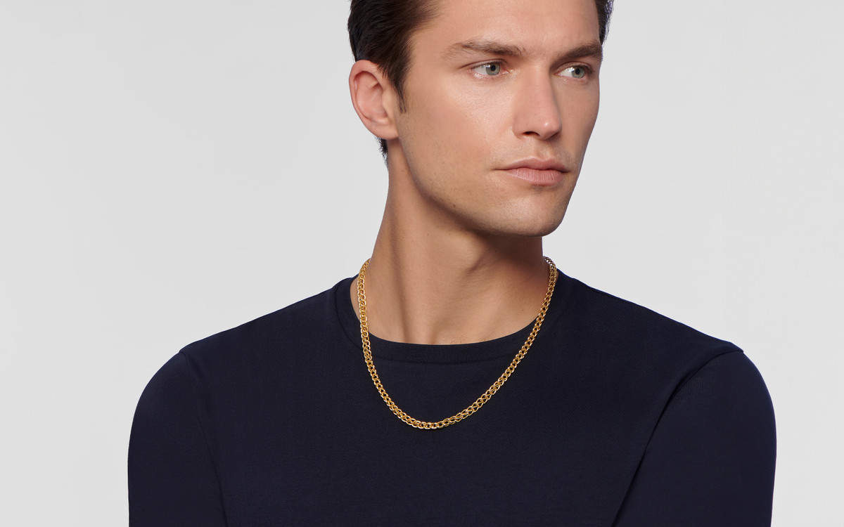 Male model wearing 22 karat gold necklace.