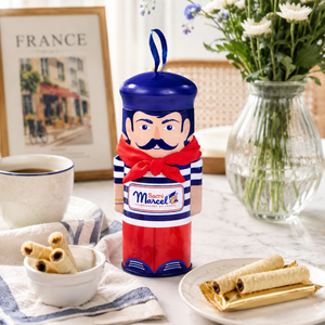 Marcel character with coffee cup and cookies on a table with flowers