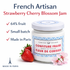 Strawberry cherry blossom preserve jar with fresh strawberries and flowers, French jam made in Paris with high fruit content.