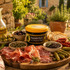 Délices du Luberon Black Olive Tapenade on a Provençal apéro board with charcuterie, olives, herbs and mini toasts