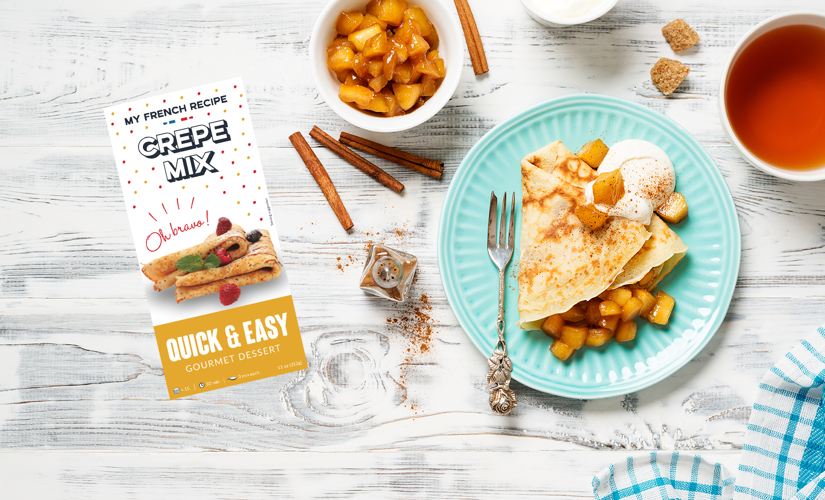 Apple cinnamon cr&ecirc;pes folded on a plate with warm caramelised apple filling