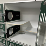 Cat Hotel Unit with forest green, glass doors. Shows the cat portal, which can be opened for cats to roam the entire unit.