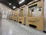 In this row you will see the tan half-glass doors on the kennels with fast feeders, clipboards, headers and custom logo. These large sturdy kennels are sure to make your boarding facility a pup's first choice. 