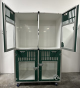 Double stacked kennel with forest green glass doors.