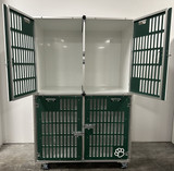 Double stacked kennel with forest green slotted gates.