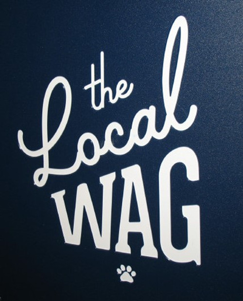 The Local Wag's custom logo engraved on their kennel gates.