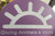 Hearts Alive Village's custom logo engraved on a purple Gator Kennels door
