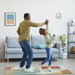 Father and daughter dancing in living room with Nest Protect