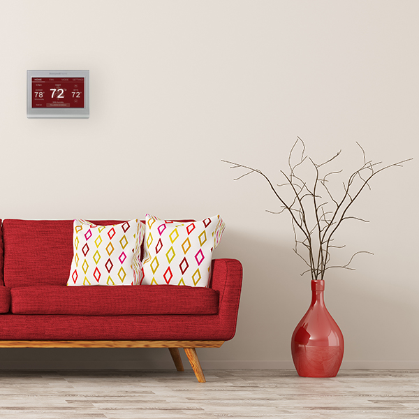 red thermostat face in living room with red couch