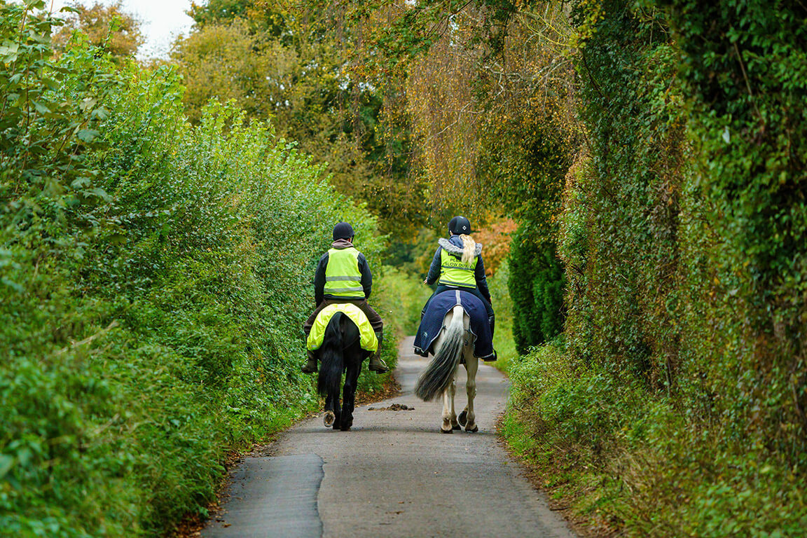 Safety tips when out hacking Two riders in hi-vis on road two abreast