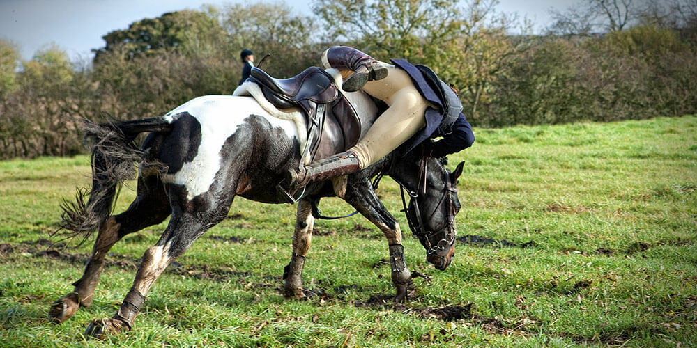 Horse rider falling off horse