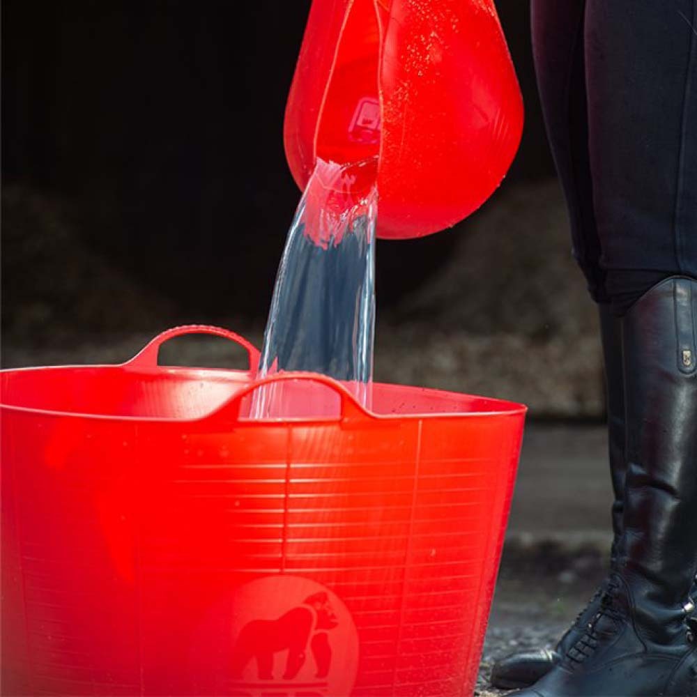 Pouring water from a red jug into a red bucket