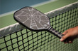 Arachne wide body lightweight raw carbon fiber pickleball paddle with 15mm polymer honeycomb core and "carbon cloth" friction technology