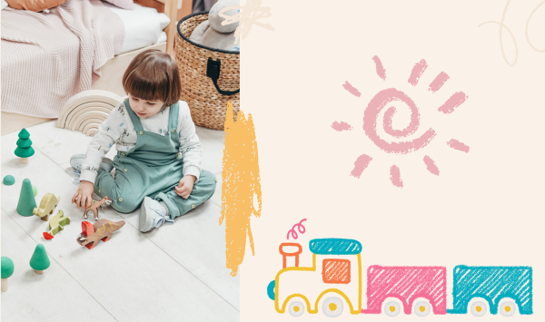 Child sitting on the floor playing with colorful wooden animal and tree toys, wearing green overalls and sneakers, next to a woven basket of stuffed animals in a cozy playroom.