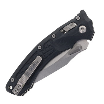 Microtech Amphibian Ram-Lok Folding Knife G10 Handle Partially Serrated Blade 137RL-2FLGTBK Microtech Amphibian Ram-Lok Folding Knife G10 Handle Partially Serrated Blade 137RL-2FLGTBK