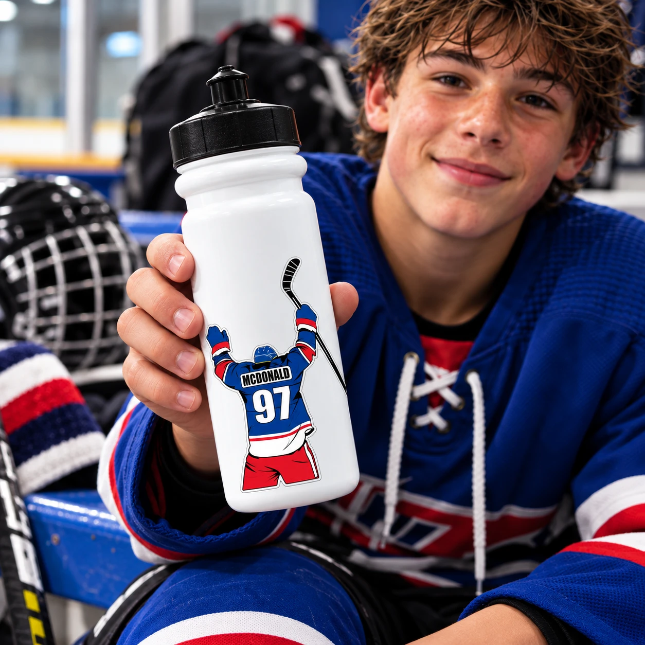 Personalized hockey water bottle sticker customized with player name, number and team colors, shown on a hockey player’s bottle.