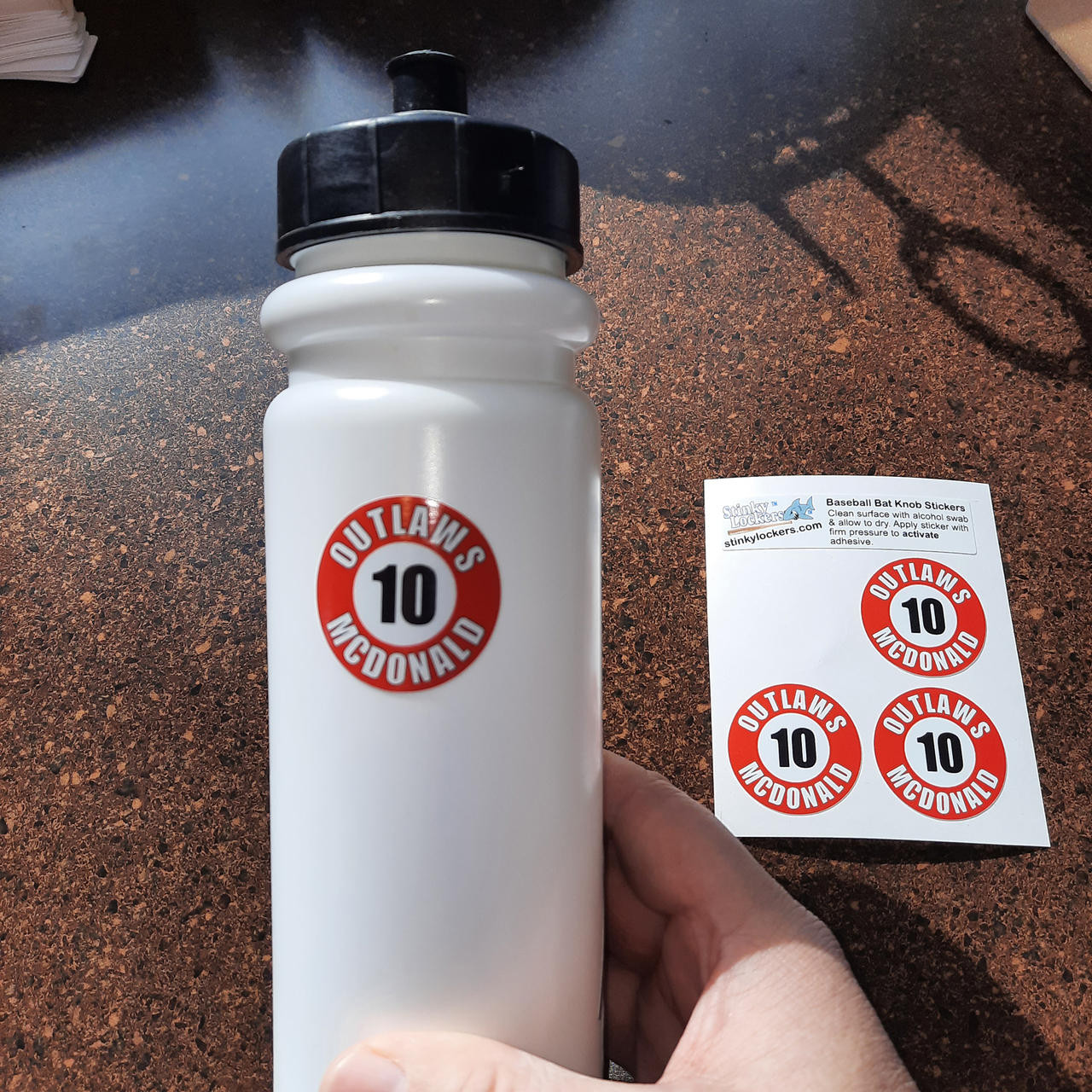 Custom baseball bat knob decal designed for travel baseball teams to label bats with player names and numbers.