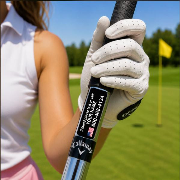Stinky Lockers Personalized Golf Club Stickers - Set of 17, close-up of a golf club with a customizable digital sticker for personal contact details, held by a golfer wearing a white glove on a golf course.