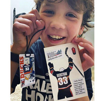 Stinky Lockers Personalized Hockey Luggage Tag OTO, a boy holding a hockey-themed luggage tag with a hockey player graphic and name 'Rockstraw' on it, smiling cheerfully.