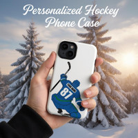 Stinky Lockers Personalized Hockey iPhone Tough Case with hockey player design on a white background, held in hand against snow-covered trees during sunset.