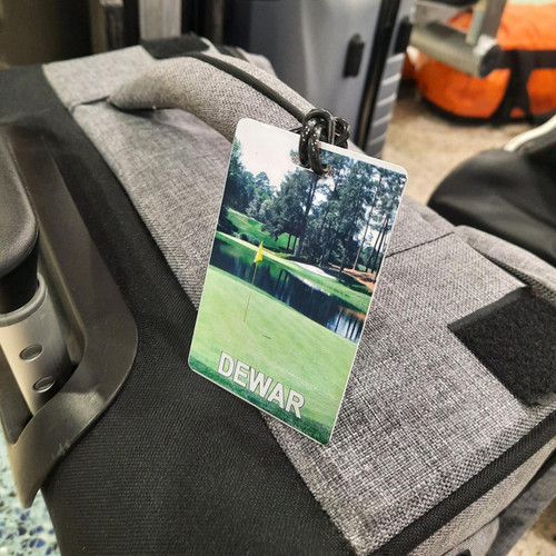 Stinky Lockers Personalized Golf Luggage Tag with Loop-OTO, featuring a golf course scene with a pond and trees.