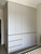 Custom casement wardrobe in Singapore bedroom — full-access hinged doors by Arimokko Shuno