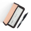 Checkbook cover with a pen.