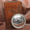 Rope edge silver concho displayed.