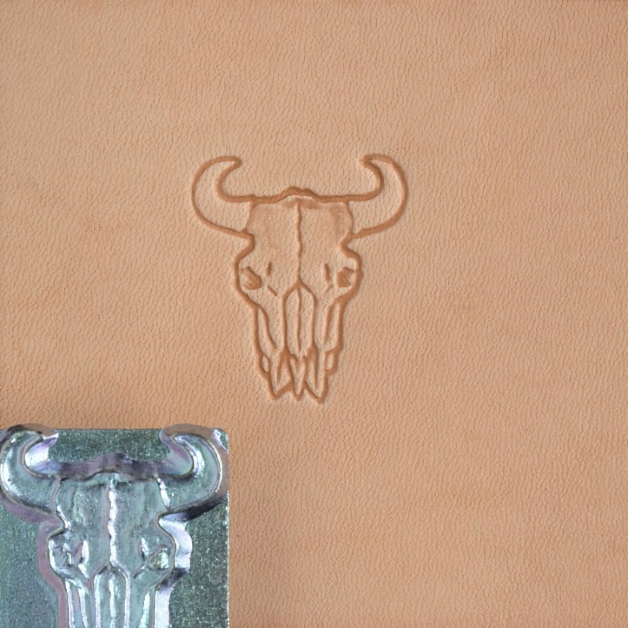 Buffalo skull leather stamp with its impression.