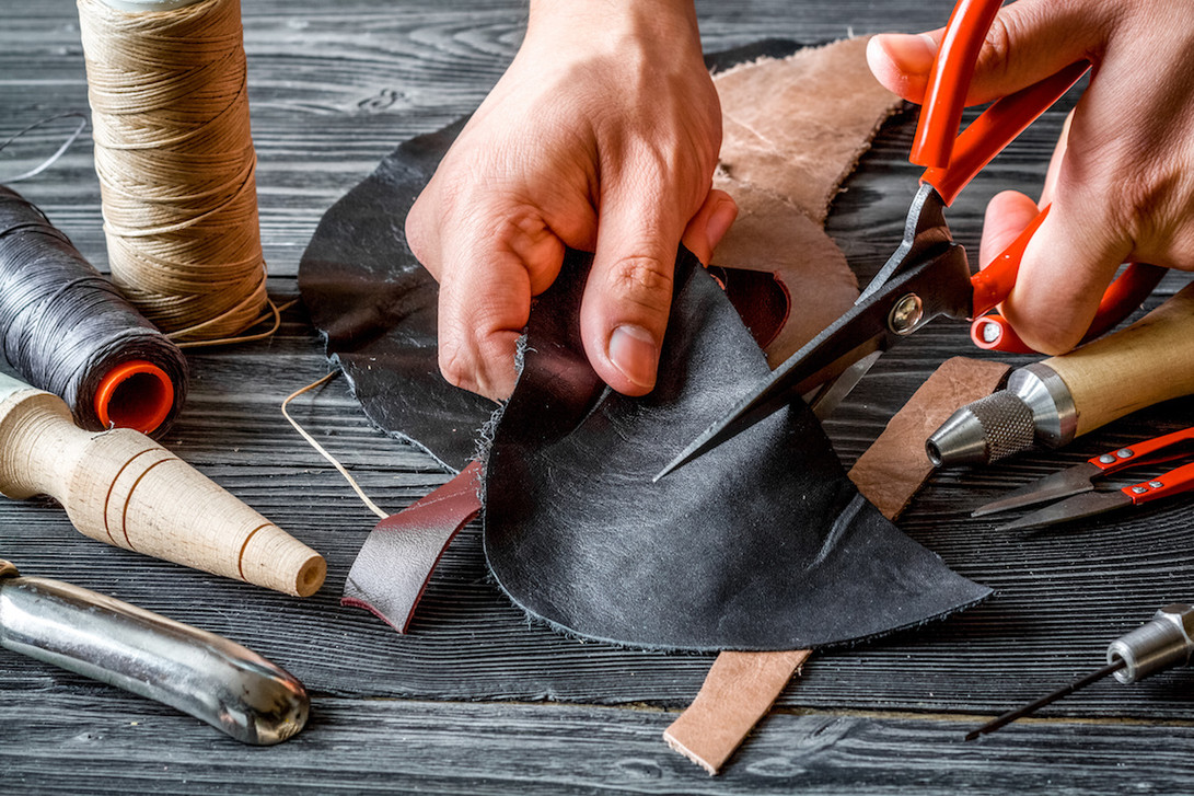 Premium Photo  Leather craft or leather working leather working tools and  cut out pieces of leather on work desk