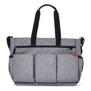 Skip Hop grey heather fabric nappy bag with black handles, multiple front pockets and zippered compartment on white