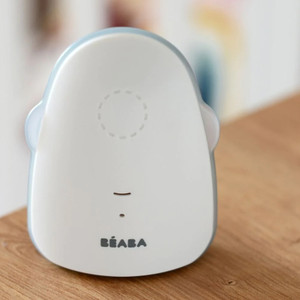 BEABA Simply Zen white baby monitor with rounded design and blue accent, sitting on wooden surface in nursery setting