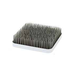 Boon grey countertop drying rack with grass-like silicone blades on white tray base against white background