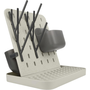 Boon Groove vertical drying rack in grey and white with baby bottles and cutlery drying on pegboard stand with drip tray