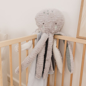 Bubble Inky the Grey Octopus soft plush toy held by baby